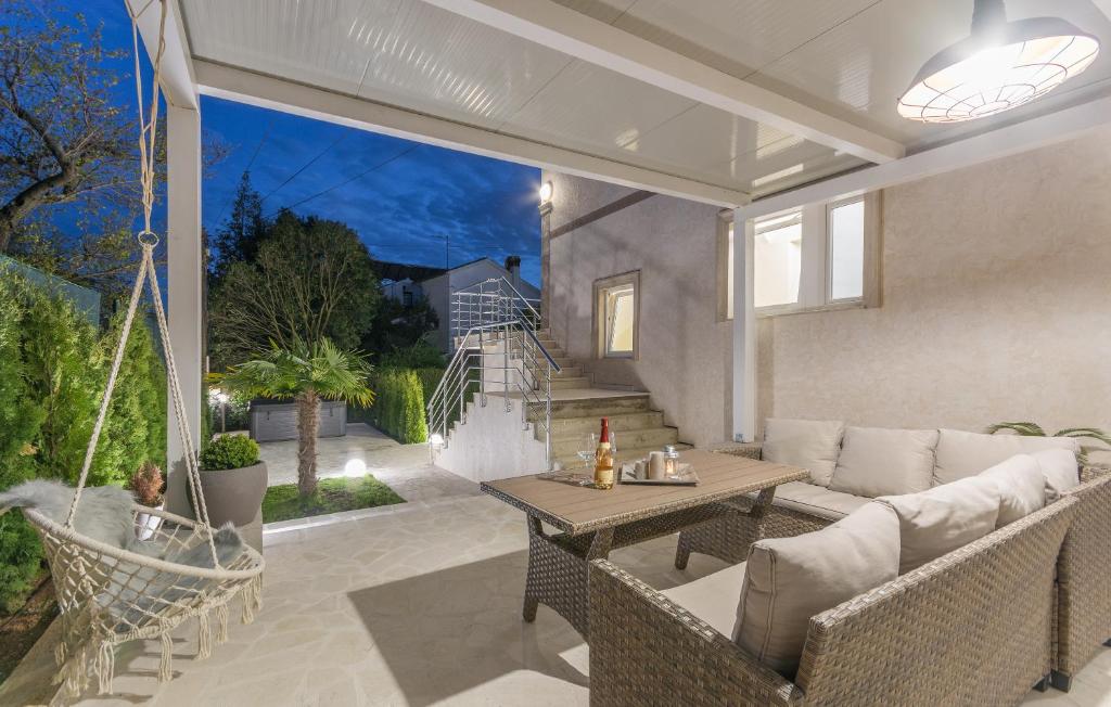 a patio with a couch and a table at Villa Stephany in Poreč