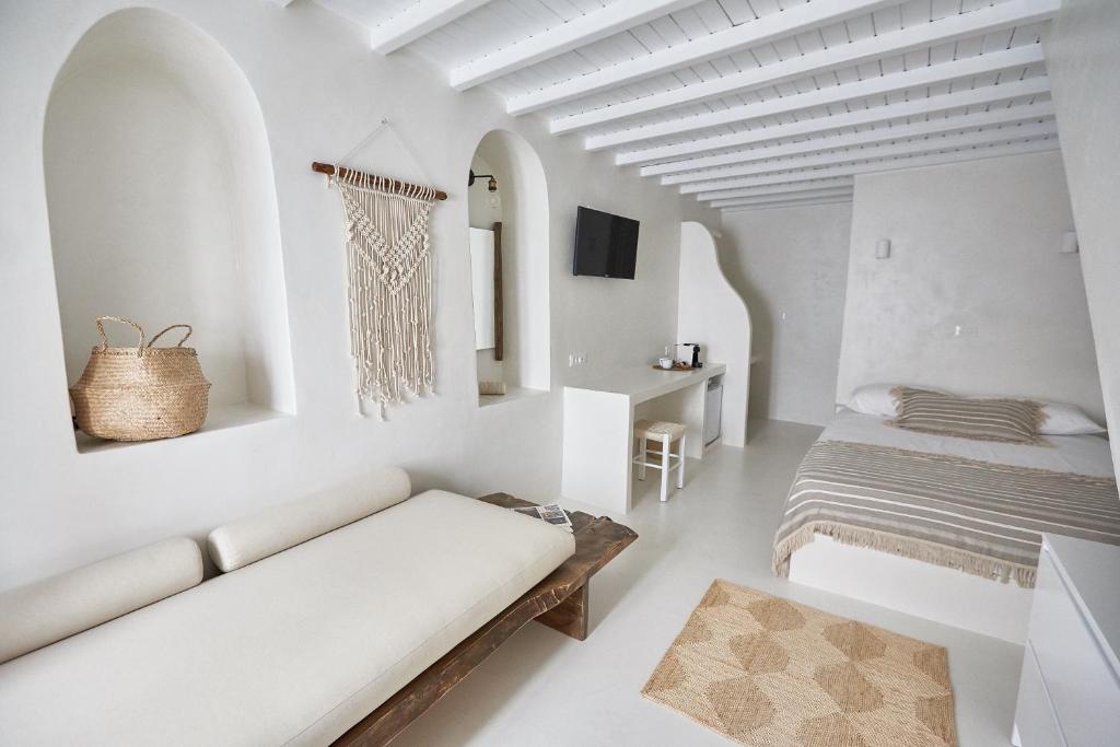 a living room filled with furniture and pillows at Blanco Rooms Mykonos in Mýkonos City