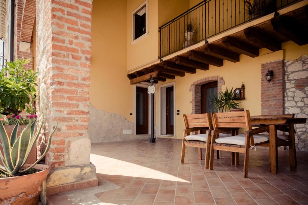 un patio al aire libre con mesa de madera y sillas en Casa Bassetto, en Longare