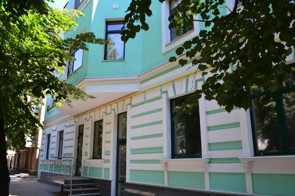 a blue and white building with a porch at Paloma House in Kharkiv