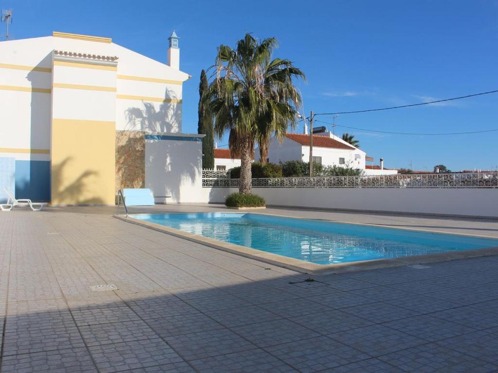 a swimming pool in front of a house at Europa Beach House in Manta Rota