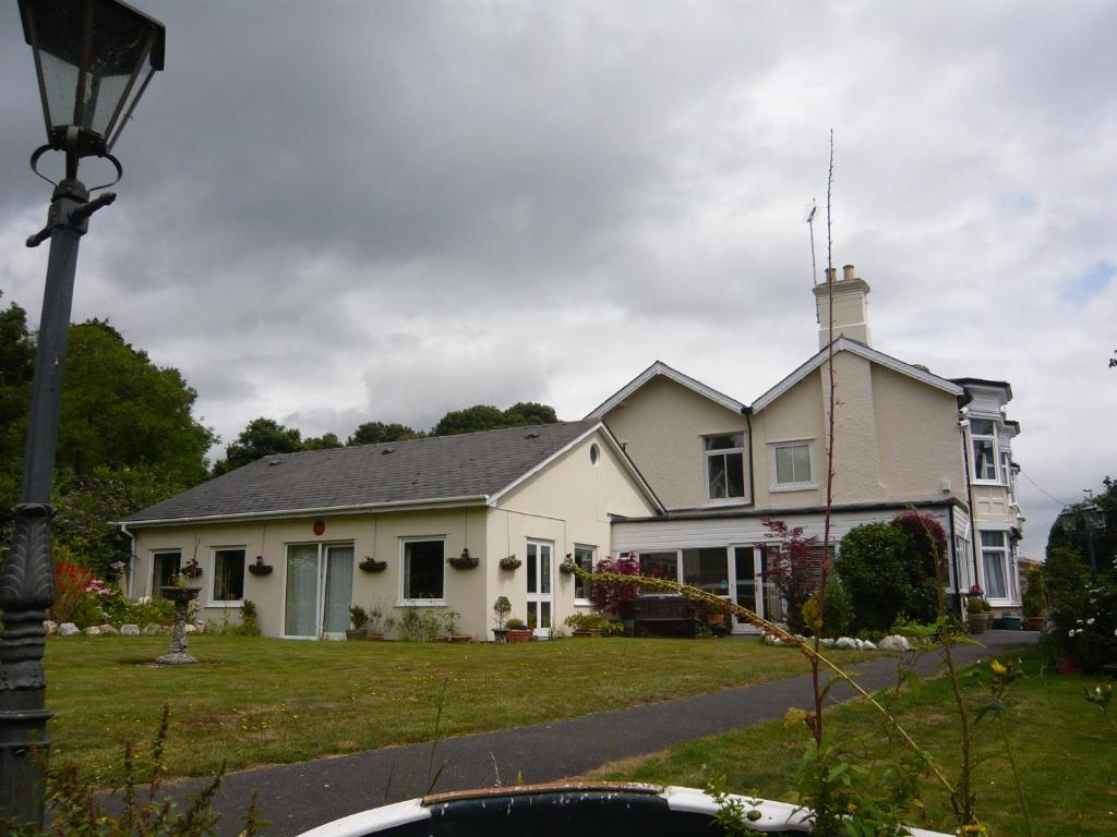 a white house with a antenna on top of it at The Croft Guest House - Cockwood Harbour Near Exeter in Exeter