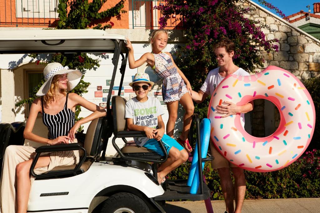 a group of people sitting in a golf cart with a giant donut at IC Hotels Santai Family Resort - Kids Concept in Belek