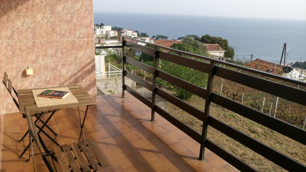 a balcony with a table and a view of the ocean at Poborska Villa in Ulcinj