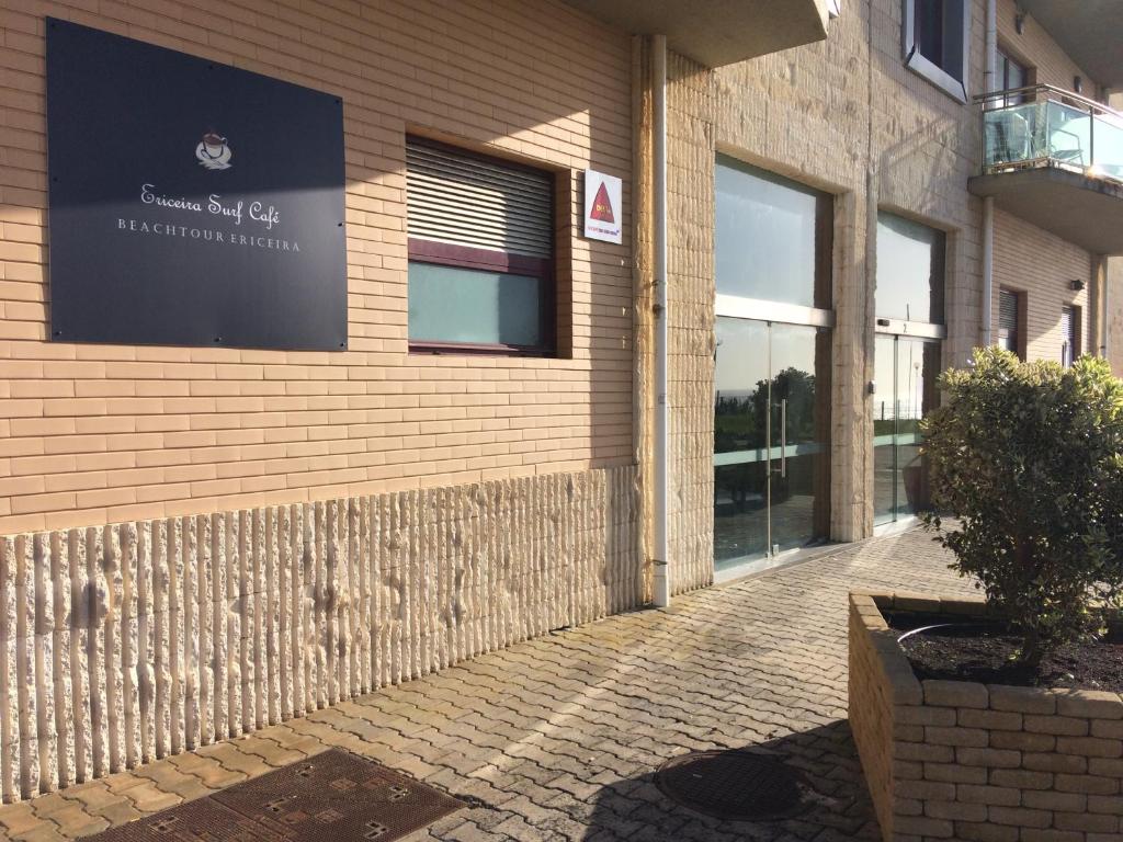 a building with a sign on the side of it at Ericeira Surf and Sun in Ericeira