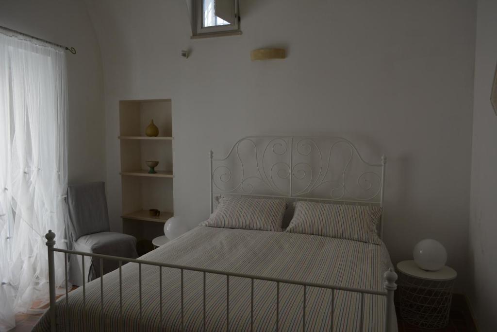 - une chambre avec un lit doté d'une tête de lit blanche et d'une fenêtre dans l'établissement San Biagio Materapartment, à Matera