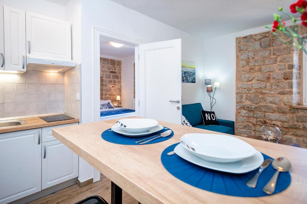 a kitchen with a table with plates on it at Villa Riva in Jelsa