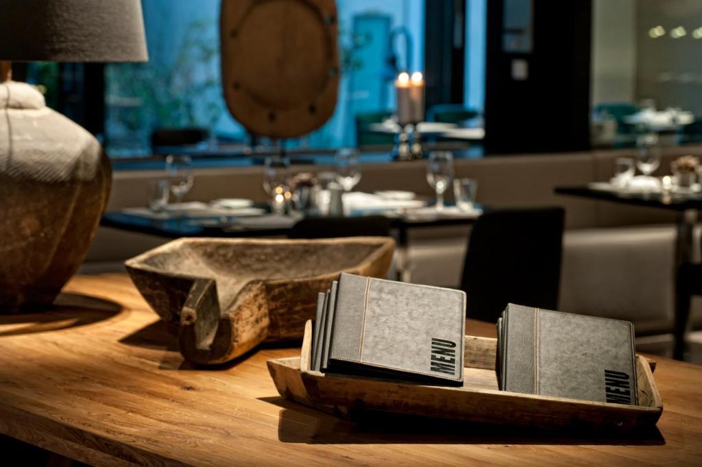 a table in a restaurant with two books on it at Wyndham Stuttgart Airport Messe in Stuttgart