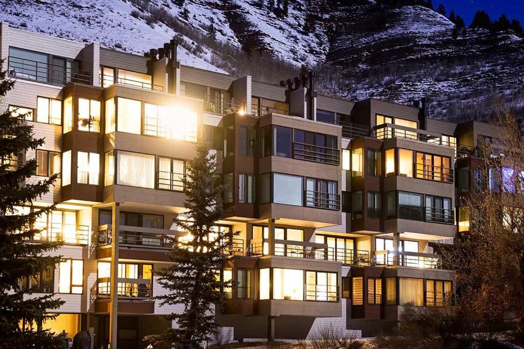 a building with lights on in front of a mountain at Simba Run Vail Condominiums in Vail