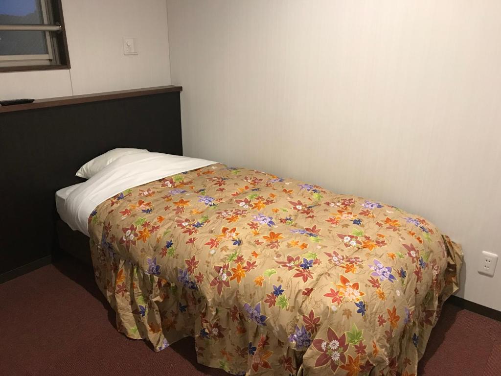 Postel nebo postele na pokoji v ubytování Hotel Famitic Nikko Station