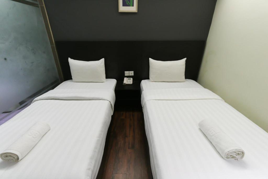 Postel nebo postele na pokoji v ubytování Hotel 99 Bandar Klang (Meru)