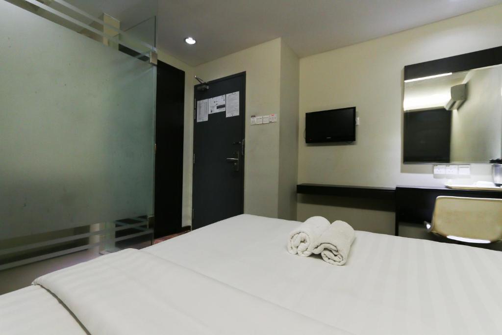 Postel nebo postele na pokoji v ubytování Hotel 99 Bandar Klang (Meru)