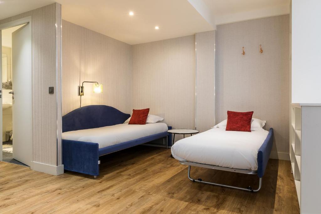 Postel nebo postele na pokoji v ubytování CADET Residence