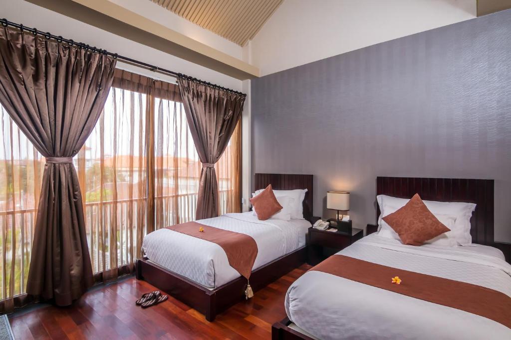 Кровать или кровати в номере 18 Suite Villa Loft at Kuta
