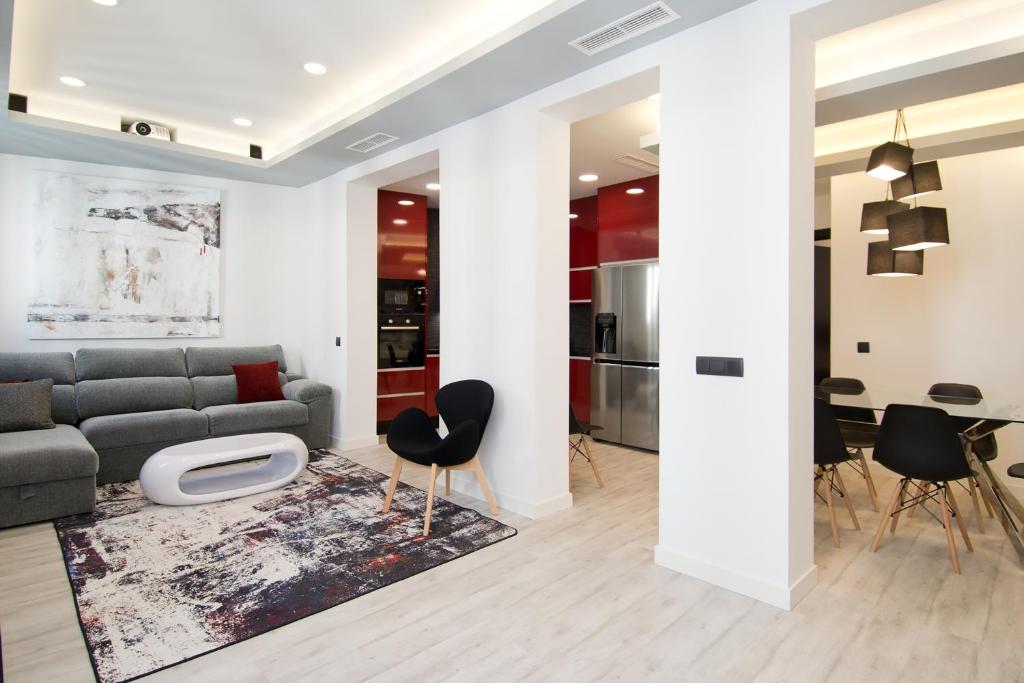 a living room with a gray couch and chairs at Condo San Bernardino by Kivoya in Madrid