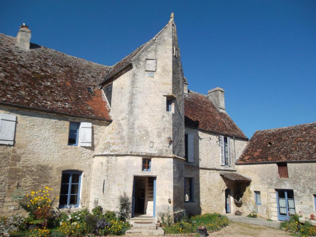 an old stone building with a tower at Manoir de Coulandon in Argentan
