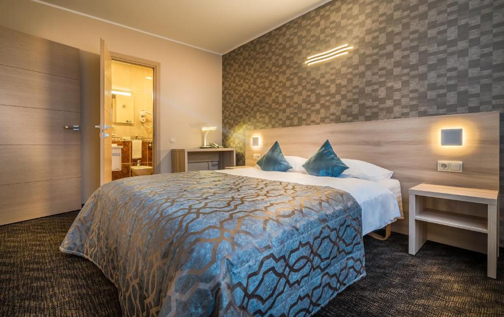 Postel nebo postele na pokoji v ubytování Hotel Zemaites
