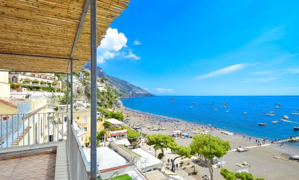 a view of a beach and the ocean from a building at AMORE RENTALS - Casa Raffi in Positano