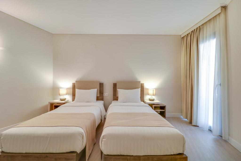 Voodi või voodid majutusasutuse Palace Hotel Glyfada toas