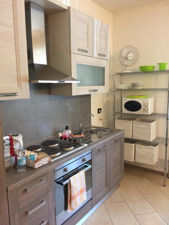 a kitchen with a sink and a stove top oven at Aurelia in Varese