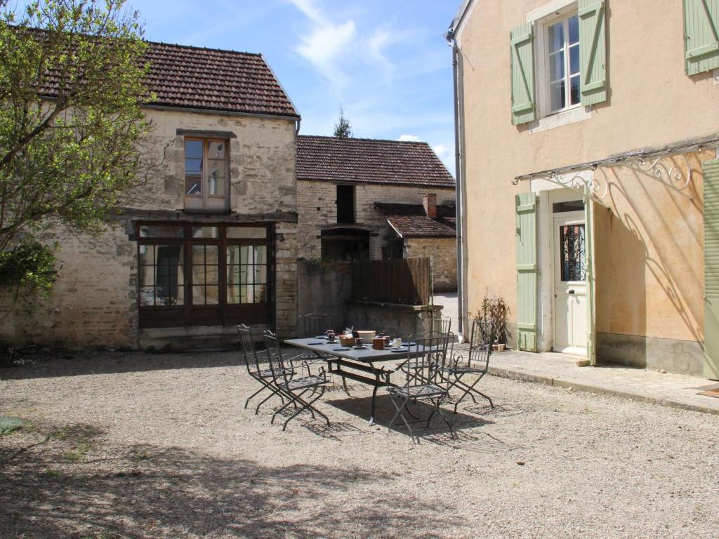 a table and chairs in front of a building at Beautiful country house with enclosed garden in green surroundings in Burgundy in Bouix