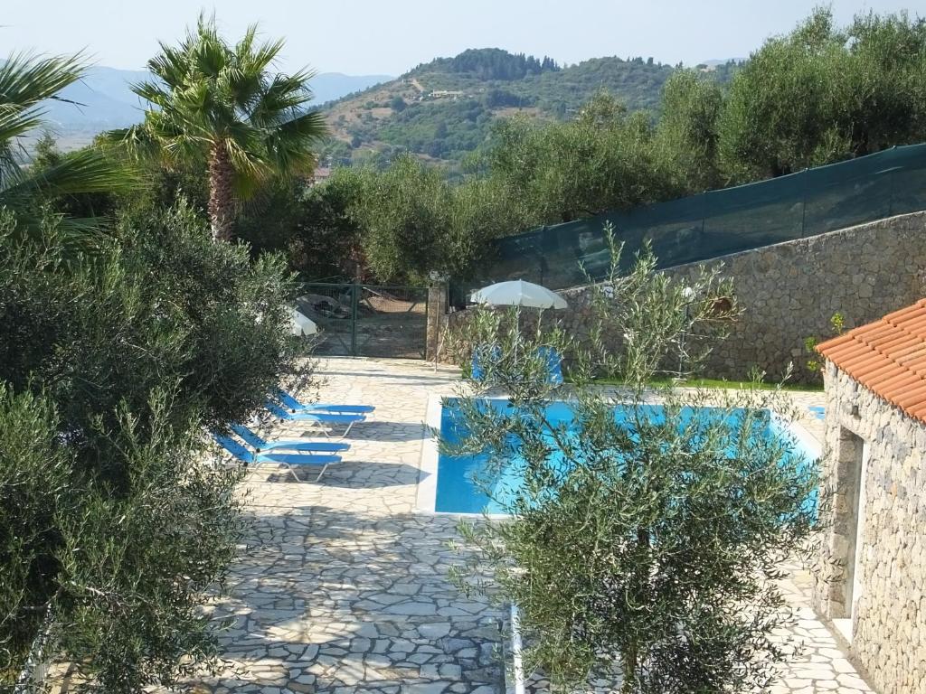 a resort with a swimming pool and trees at Corfu Villa Kokkini with swimming pool in Kokkínion