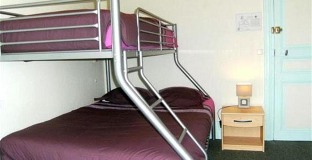 Postel nebo postele na pokoji v ubytování Hotel le Rallye