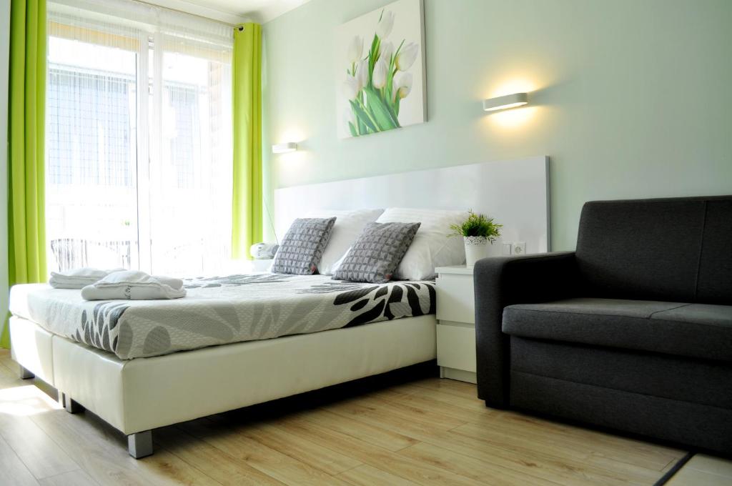 Postel nebo postele na pokoji v ubytování Apartamenty Feniks & Pegaz