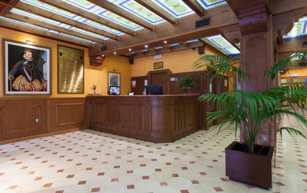 a lobby with a waiting room with a reception desk at Agora Juan de Austria in Madrid