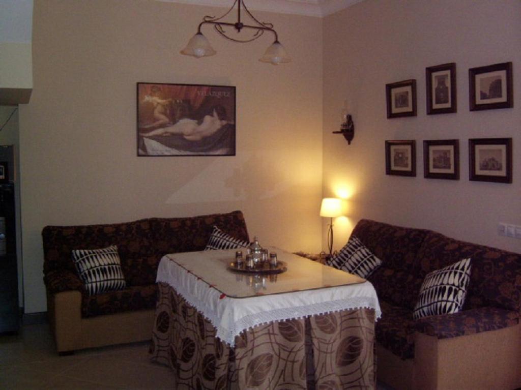 a living room with a couch and a table at El Palacete in Setenil