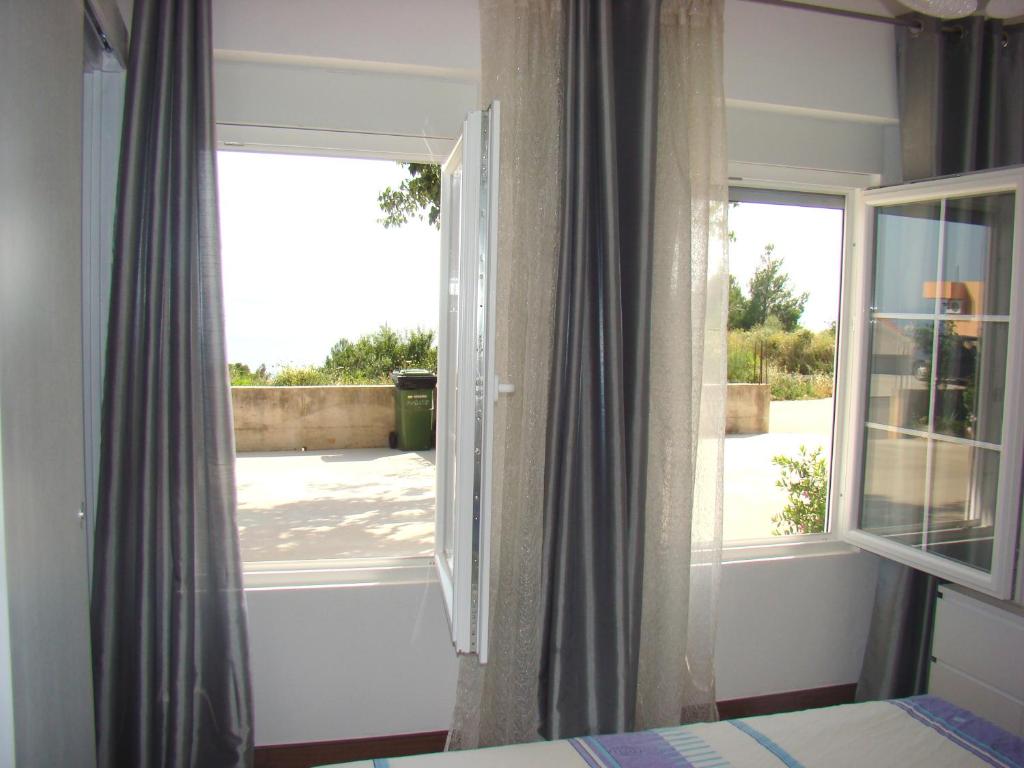 a bedroom with a window with a view of a yard at Apartment Mativa in Makarska