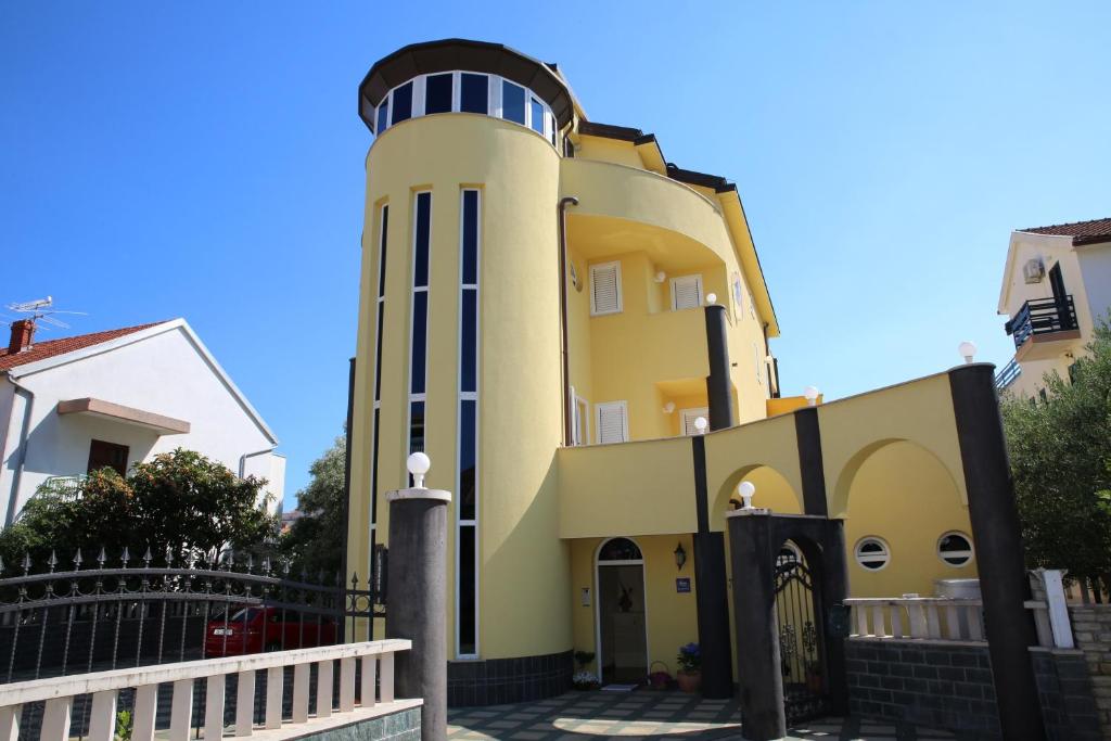 a building with a lighthouse on top of it at Vila Nara in Vodice