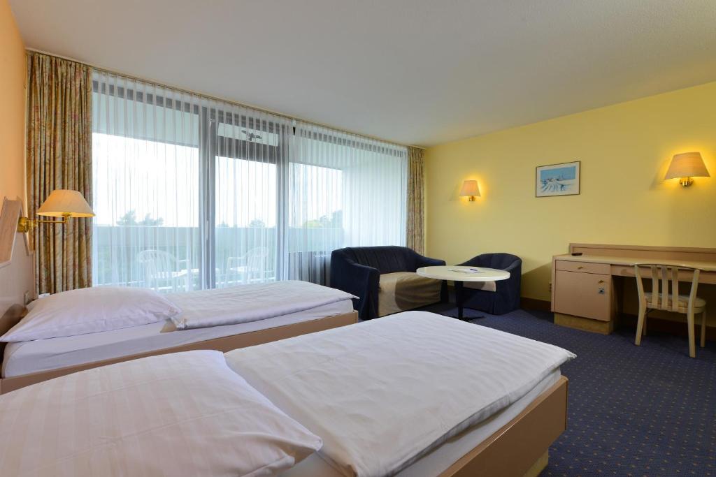 Postel nebo postele na pokoji v ubytování Hotel Sonnenhügel