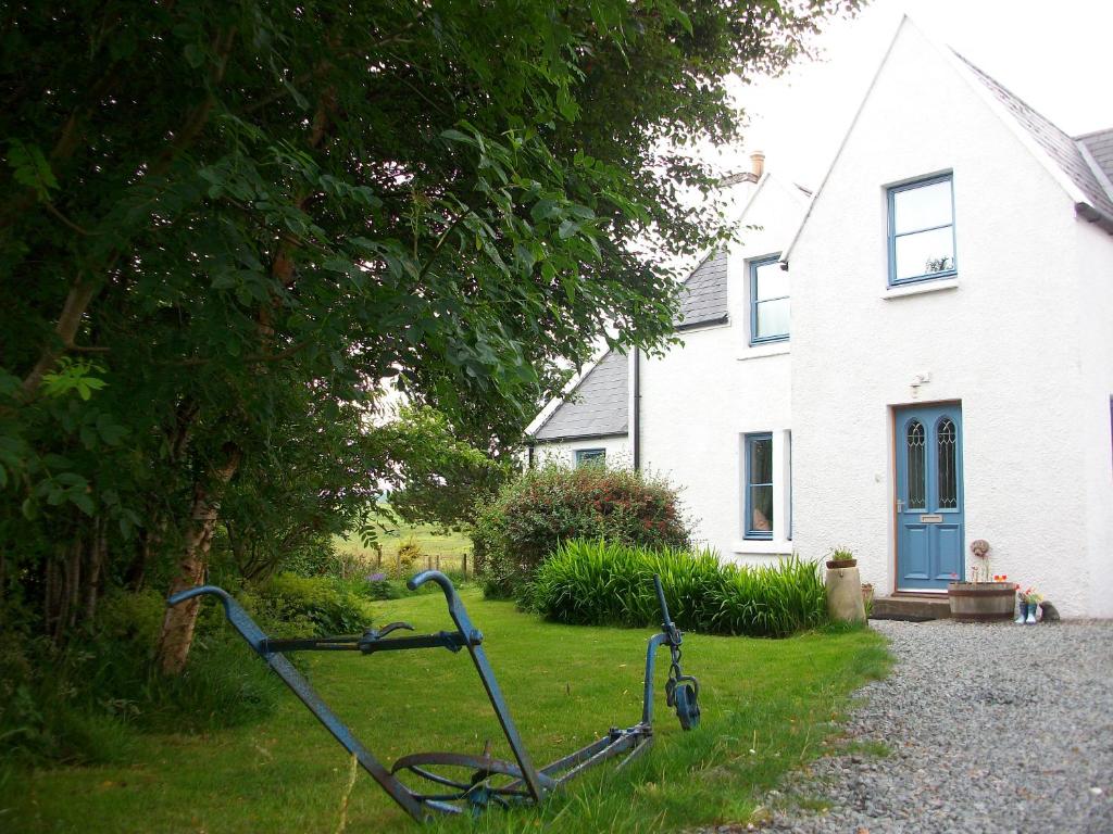 a bike parked in the grass in front of a house at The Old Croft House in Portree