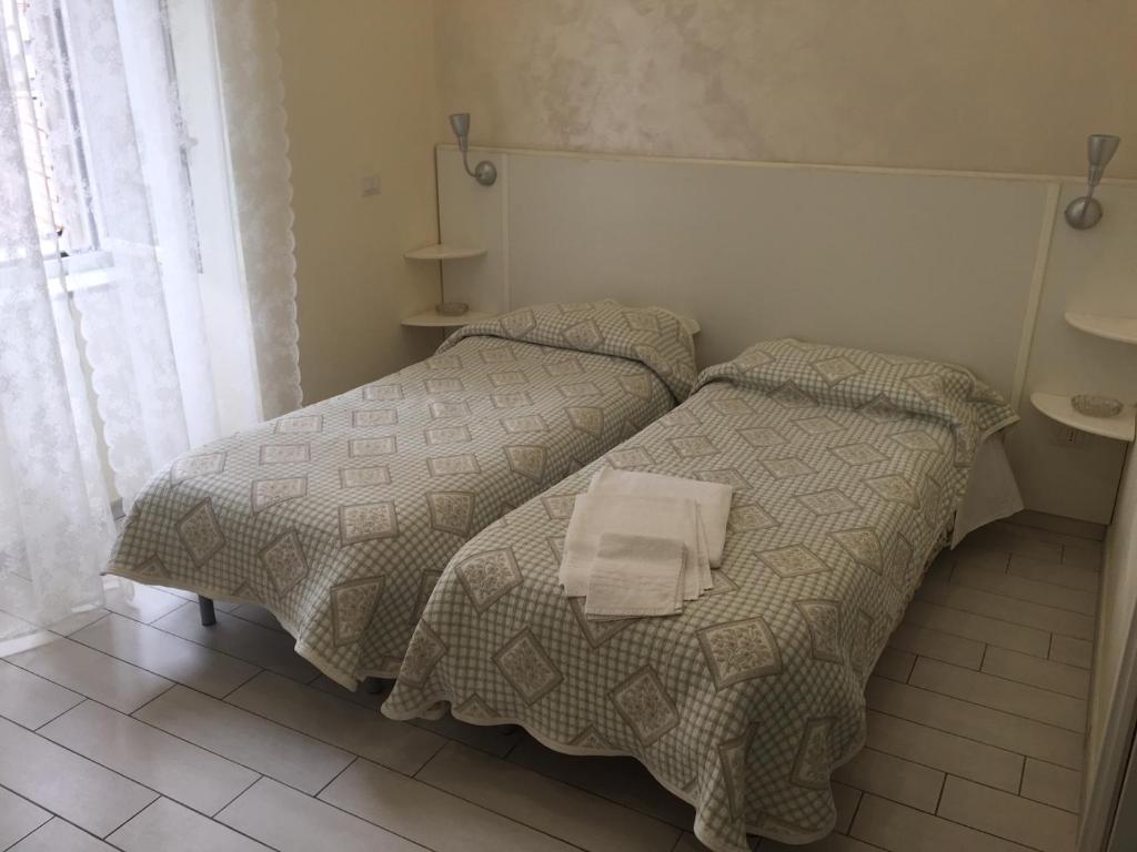 Postel nebo postele na pokoji v ubytování Albergo Oasi