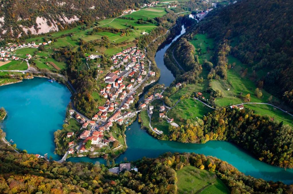 an aerial view of a village next to a river at Apartma Opendoors Postaja in Most na Soči