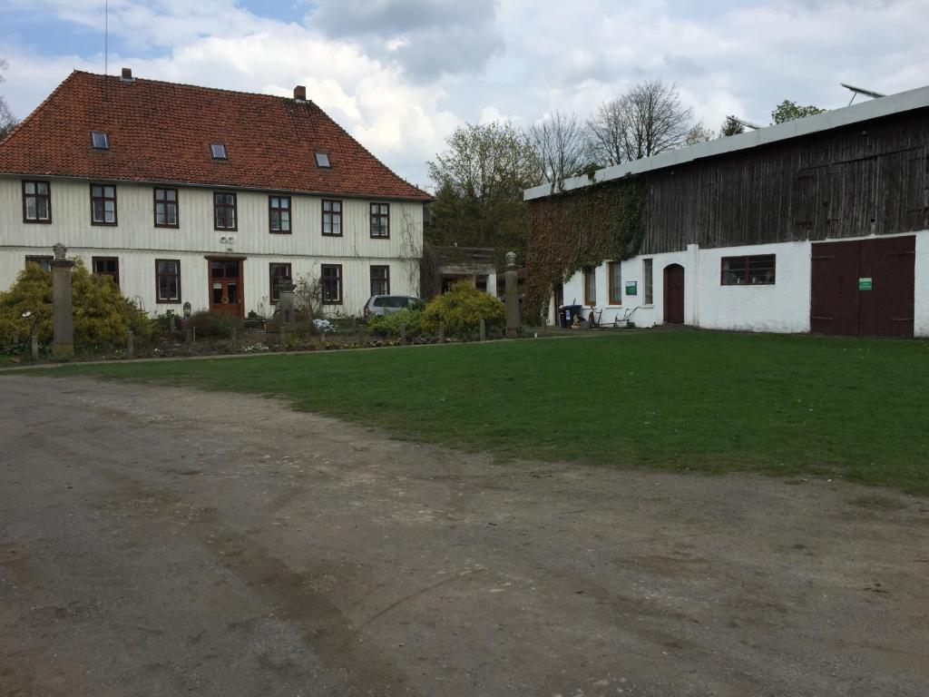 a large white building with a red roof at Biogut Evensen in Evensen