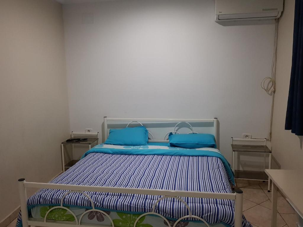 Una cama o camas en una habitación de Hotel Afef