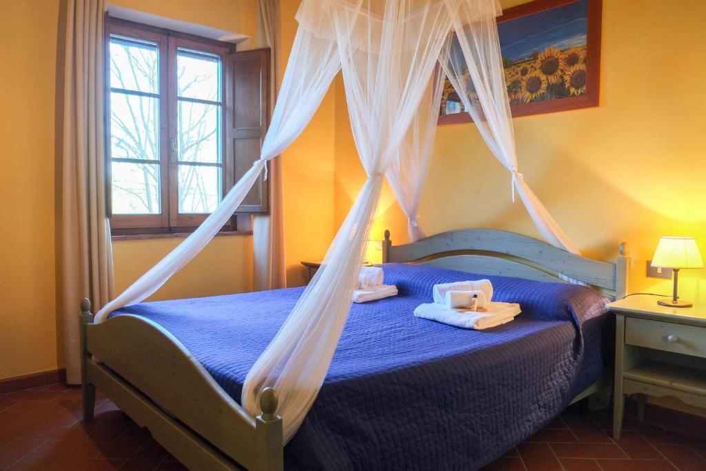 Postel nebo postele na pokoji v ubytování Borgo Poneta
