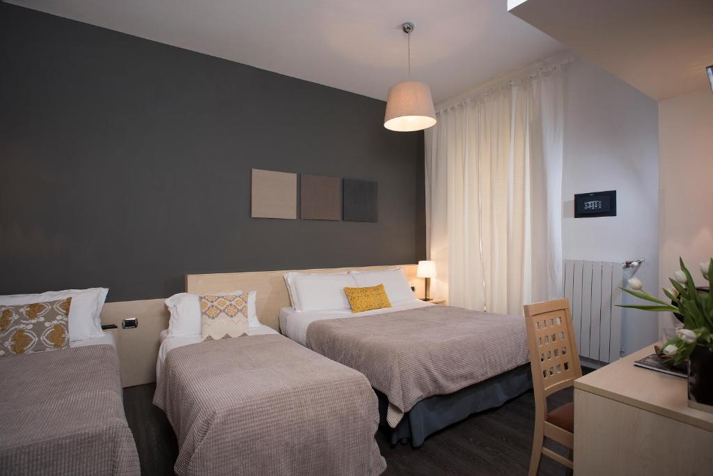 A bed or beds in a room at 111 ColaDiRienzo Rooms - by AD Roma
