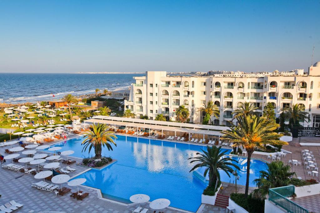 an overhead view of a resort with a swimming pool and the ocean at El Mouradi Mahdia in Mahdia