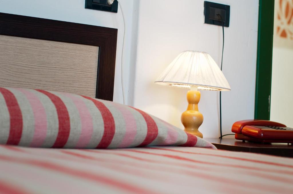 Postel nebo postele na pokoji v ubytování Hotel Milan