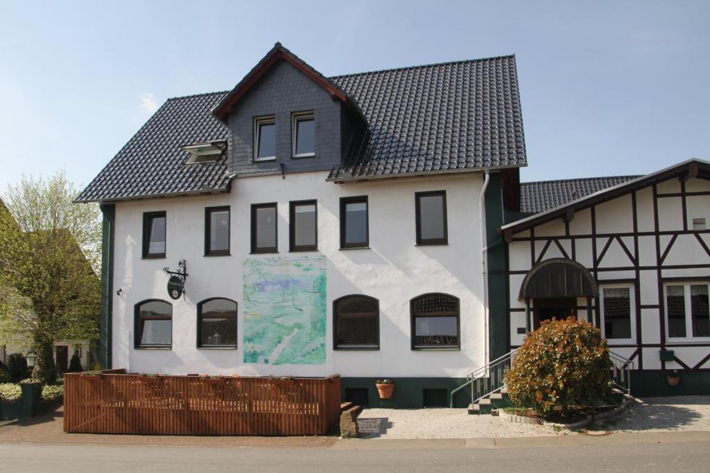 a large white building with a black roof at Derentaler Hof in Derental