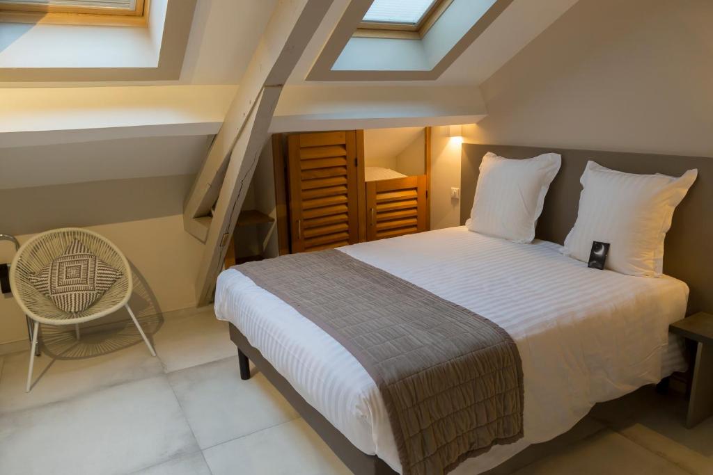 Postel nebo postele na pokoji v ubytování Hotel Jean Moët