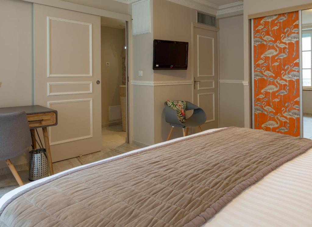 Postel nebo postele na pokoji v ubytování Hotel Jean Moët