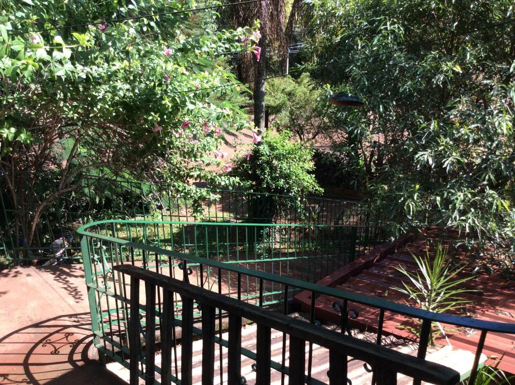 a green fence in front of a garden at Zorzal 1 in Puerto Rico