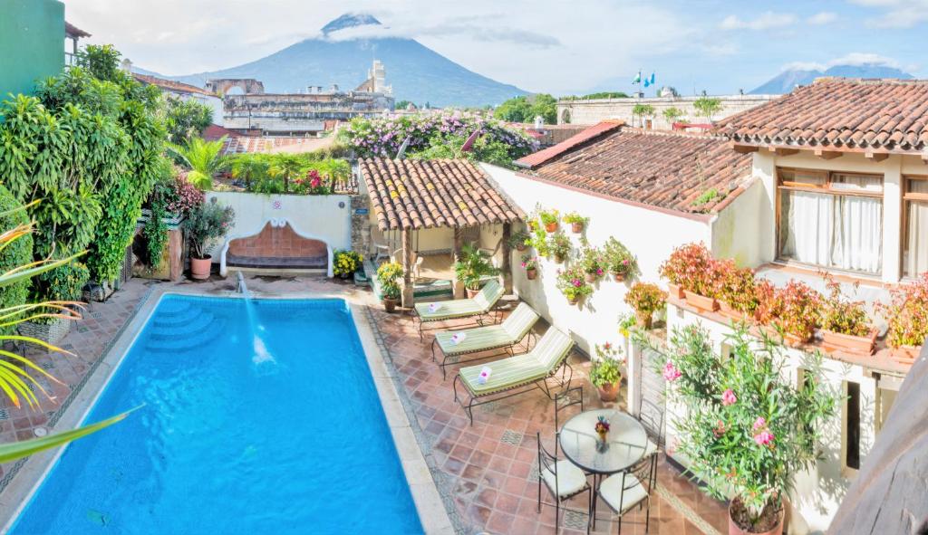 an image of a house with a swimming pool at Hotel Casa del Parque by AHS in Antigua Guatemala