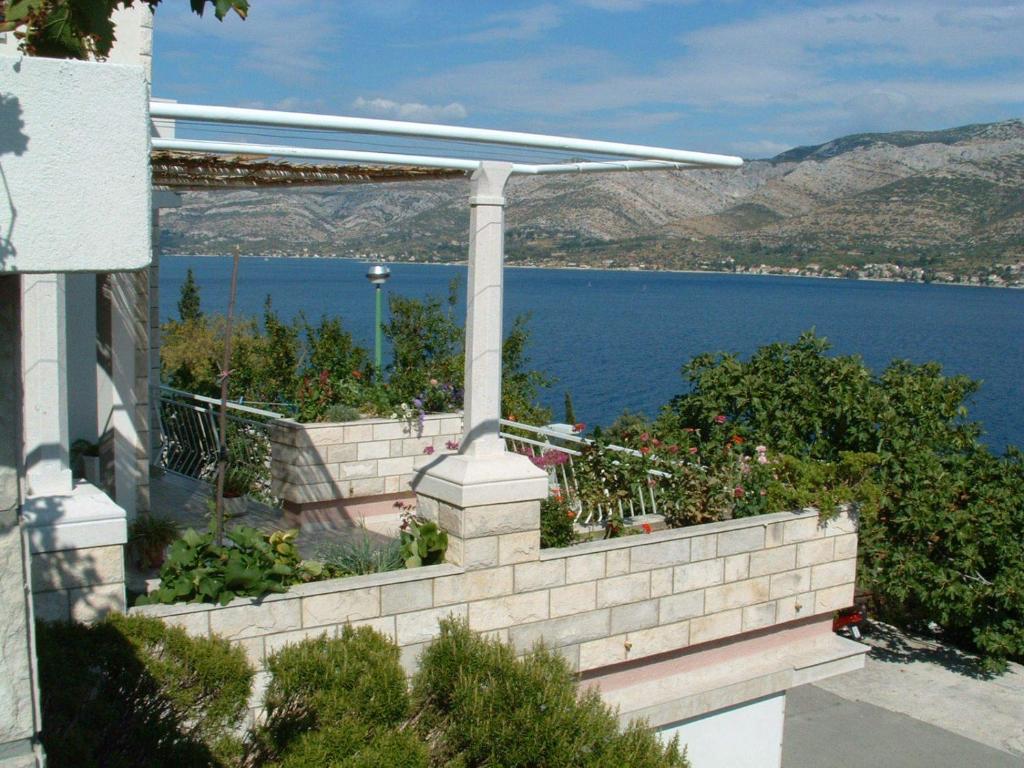 a retaining wall with a view of the water at Apartment Lucija in Korčula