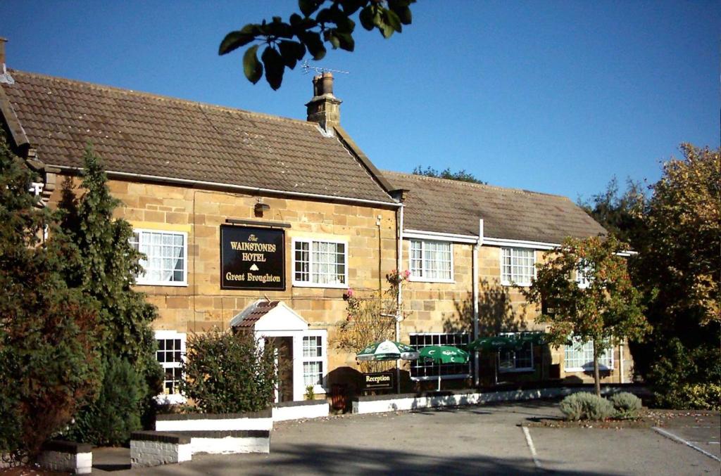 a building with a sign on the front of it at Wainstones Hotel in Stokesley