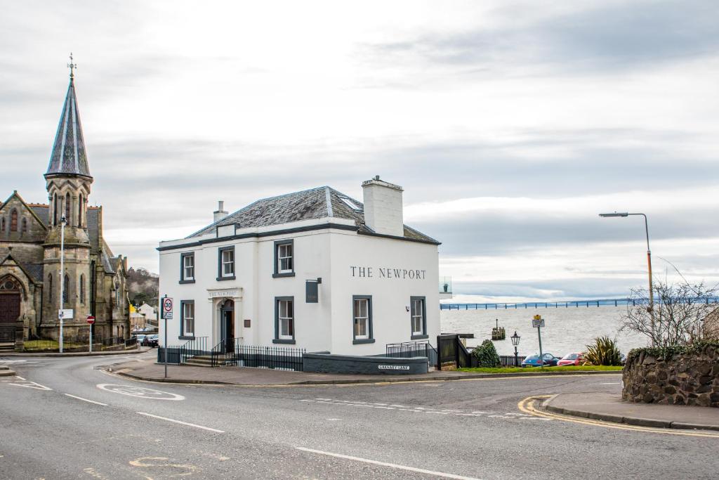 a white building on the corner of a street at The Newport Restaurant with Rooms in Newport-On-Tay